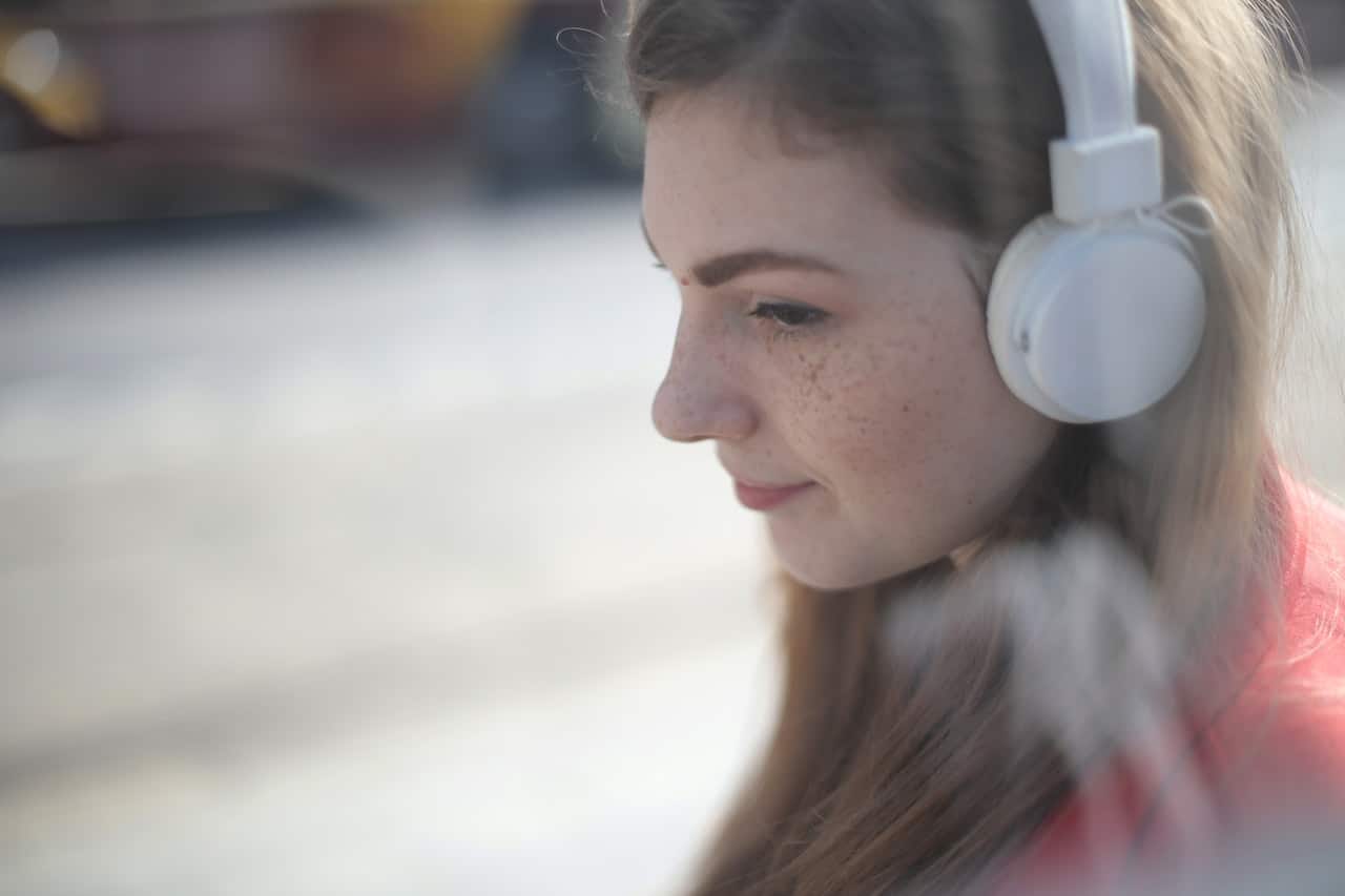 woman listening to podcast on headhones