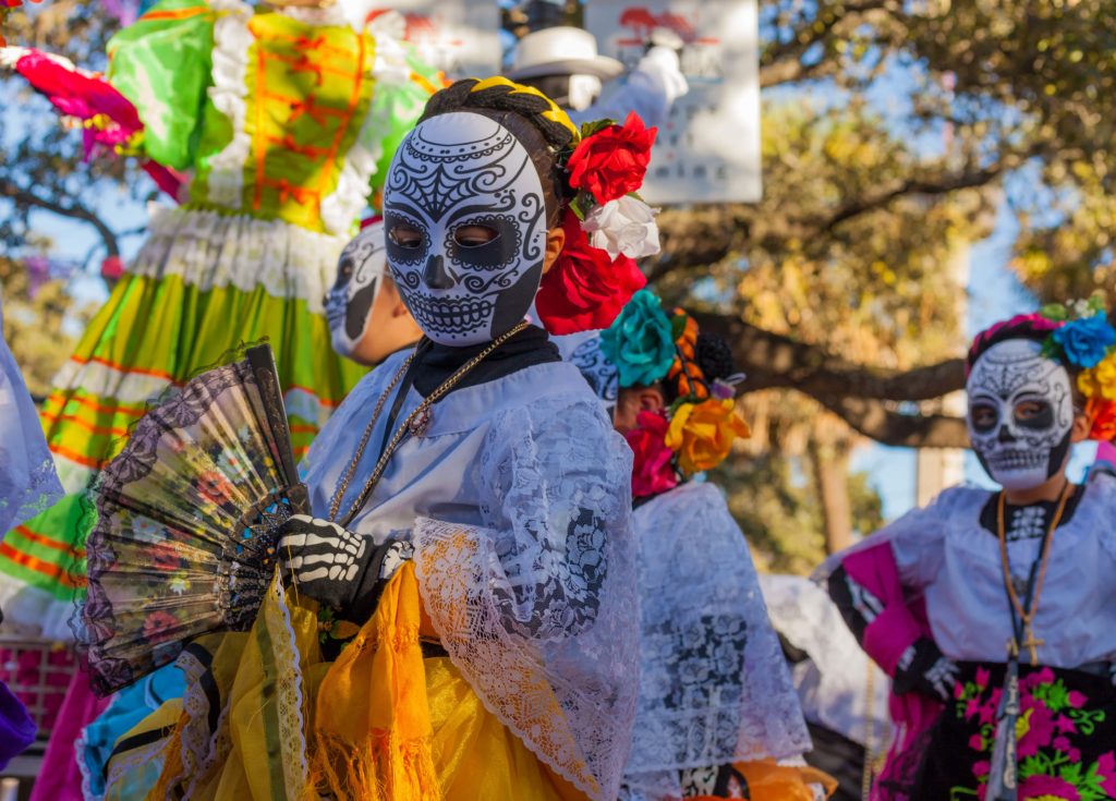 Halloween traditions in Mexico. Women wearing sugar skulls and costume